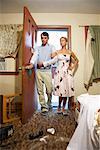 Couple Entering Messy Motel Room