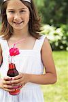 Girl Holding Bottle of Soda Pop