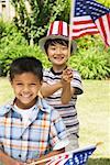 Portrait of Boys Holding American Flags