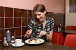 Woman Eating Dinner in Restaurant