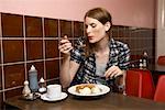 Woman Eating Dinner in Restaurant