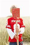 Portrait of Boy with Shovel Covering Face