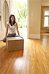 Woman Holding Box in Home