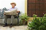 Man Reading Newspaper Outdoors