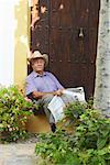 Man Reading Newspaper Outdoors