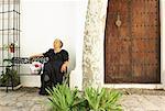 Woman Sitting on Bench Outdoors