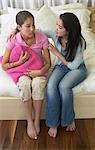 Girl Comforting Friend on Bed