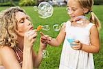 Mother and Daughter Blowing Bubbles