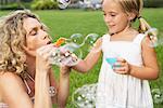 Mother and Daughter Blowing Bubbles