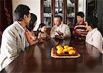 Family Sitting around Dining Table