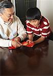 Grandfather and Grandson Holding Ang Pow Envelopes