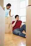 Woman Packing, Man on Cellular Phone