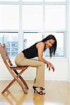 Woman Sitting on Chair in Condo