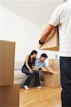Couple Unpacking Boxes in New Home