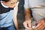 Boy Looking at Man's Pocket Watch