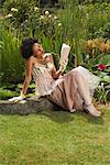 Woman Sitting By Pond, Reading a Book