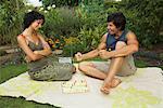 Couple Playing Board Game Outdoors