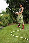 Portrait of Woman Watering Garden