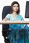 Portrait of a businesswoman sitting in front of a computer