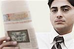 Portrait of a businessman holding a newspaper