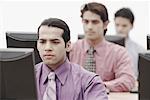 Business executives working on computers in an office