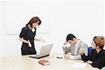 Businesswoman shouting at a businessman