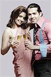 Portrait of a young couple holding champagne flutes