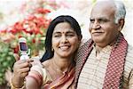 Close-up of mature couple looking at a mobile phone