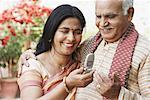 Close-up of a mature couple looking at a mobile phone