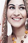 Close-up of a young woman in traditional clothing smiling