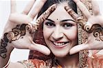 Close-up of a young woman with henna tattoo's on her hands