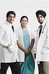 Portrait of two male doctors and a female doctor standing together