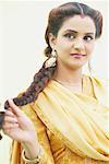 Close-up of a young woman holding her plait