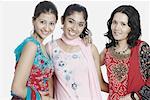 Portrait of three young women smiling