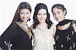 Portrait of three young women smiling