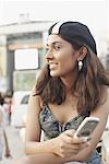 Close-up of a young woman holding a mobile phone