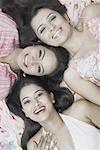 High angle view of three young women smiling