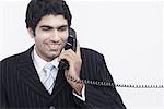 Businessman talking on the telephone smiling