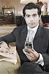 Portrait of a businessman holding a mobile phone