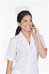 Close-up of a female nurse talking on a mobile phone