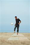 Barefoot male with soccer ball