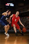 Two young Asian basketball players competing