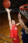 Young Asian basketball players on court