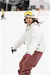 Cute young Asian snowboarder