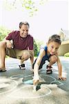 Father and Son Drawing with Chalk