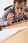 Businessman Playing with Paperclips