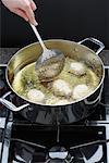 Sour Cream Doughnuts Cooking in Oil