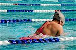 Rear view of a young woman swimming in a swimming pool