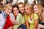 Five young women taking a photograph of themselves