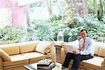 Portrait of a businessman sitting on a couch with a laptop